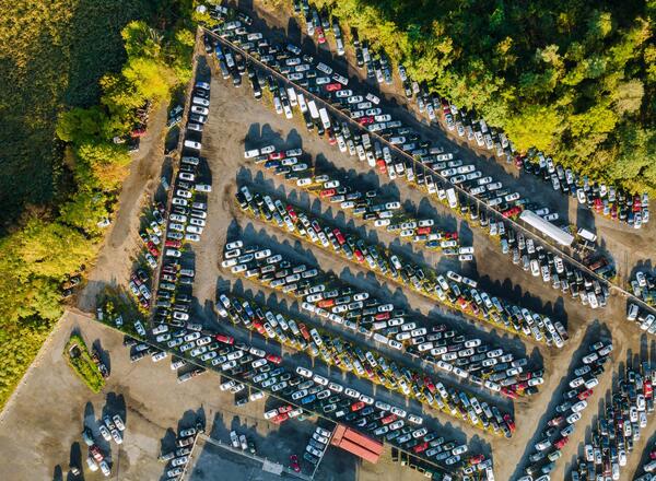 Aerial view of hundreds of vehicles lined up at a public car auction in Dallas TX